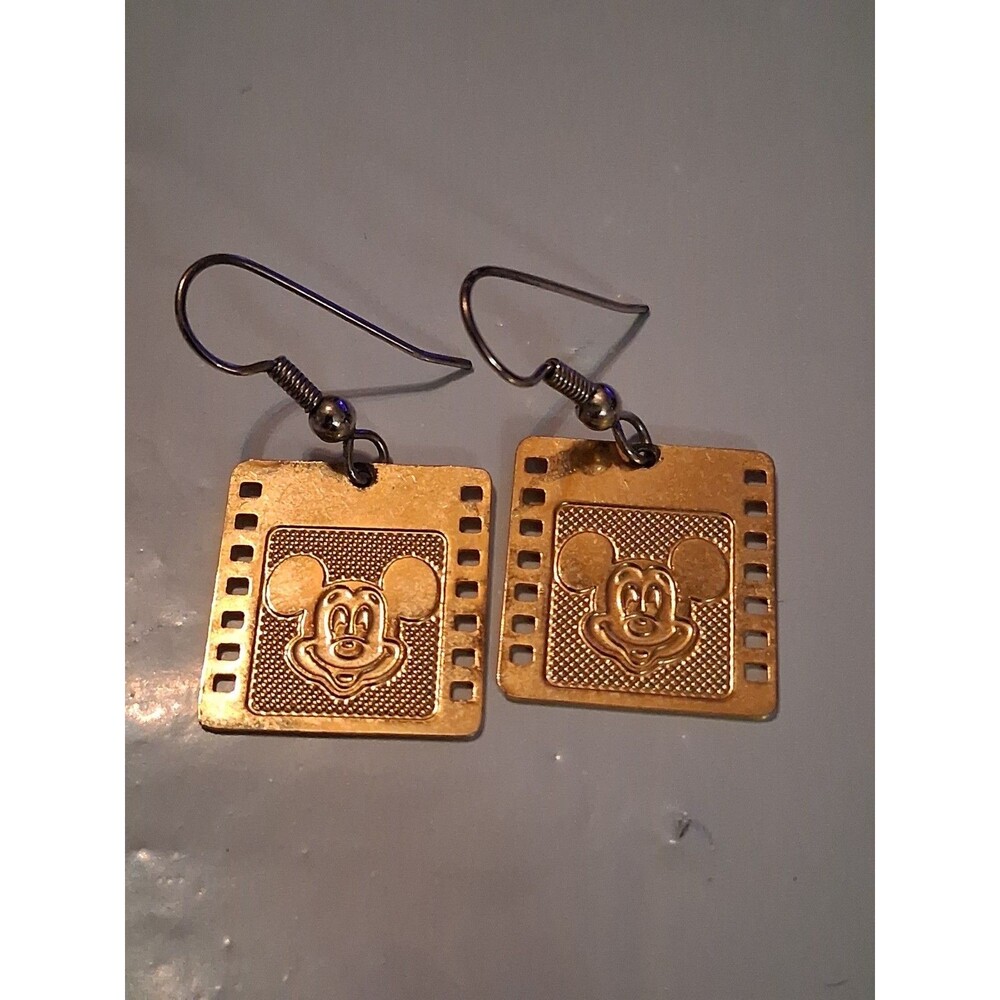 Disney Mickey Mouse gold-tone filmstrip dangle earrings featuring a smiling...
